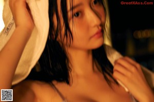 A woman with a towel wrapped around her head.