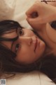 A woman laying on top of a bed in lingerie.